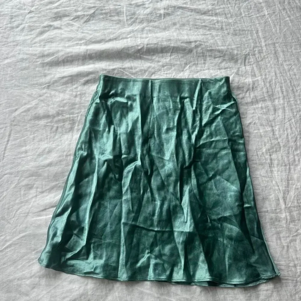 Green satin mini skirt in
